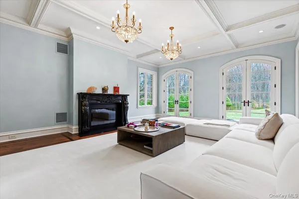 a living room with furniture and a chandelier