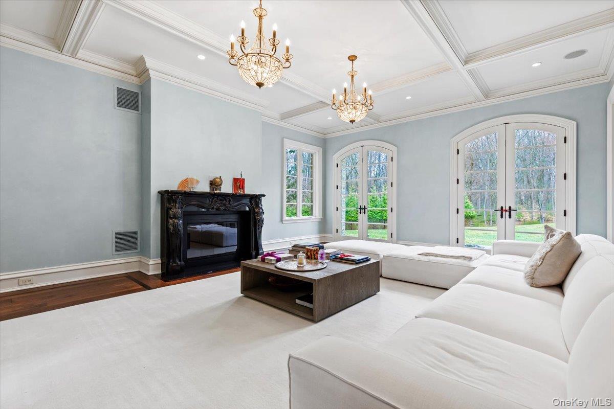 72 Guard Hill Road Bedford Corners, NY 10549 - Photo 16 of 50 a living room with furniture and a chandelier