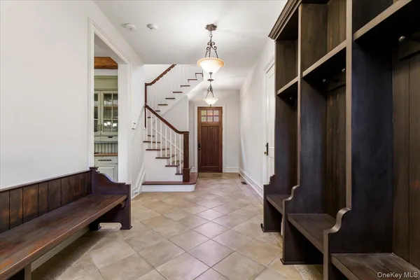a view of entryway and hall with wooden floor