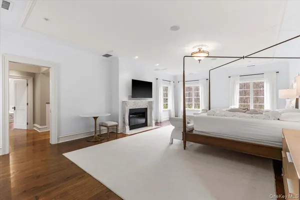 a bedroom with furniture and a large window