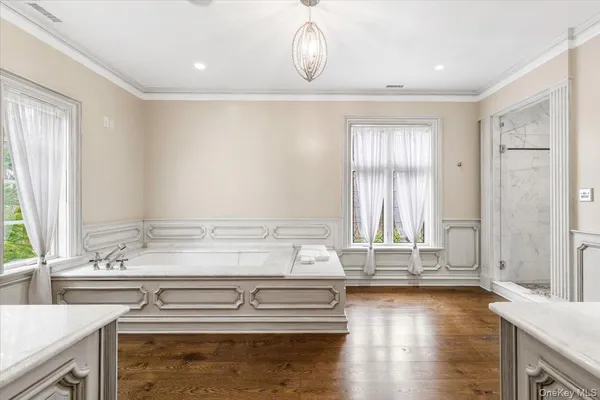 a spacious bathroom with a double vanity sink and mirror