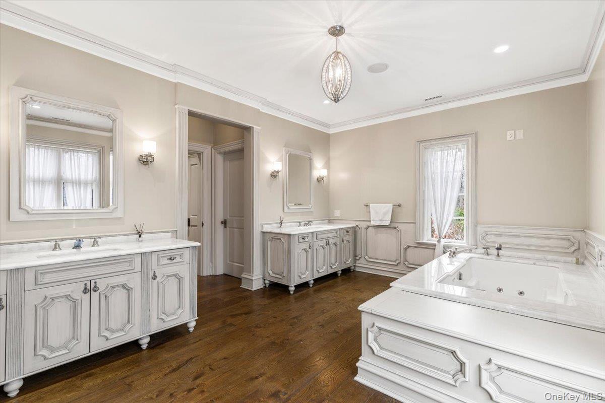 72 Guard Hill Road Bedford Corners, NY 10549 - Photo 28 of 50 a bathroom with double vanity sink a mirror and a bathtub