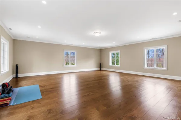 an empty room with a cabinet and mirrors
