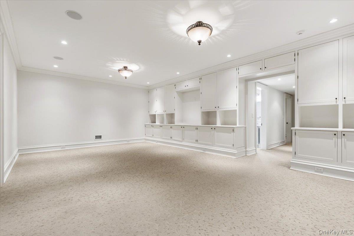 72 Guard Hill Road Bedford Corners, NY 10549 - Photo 36 of 50 an empty room with a cabinet and mirrors