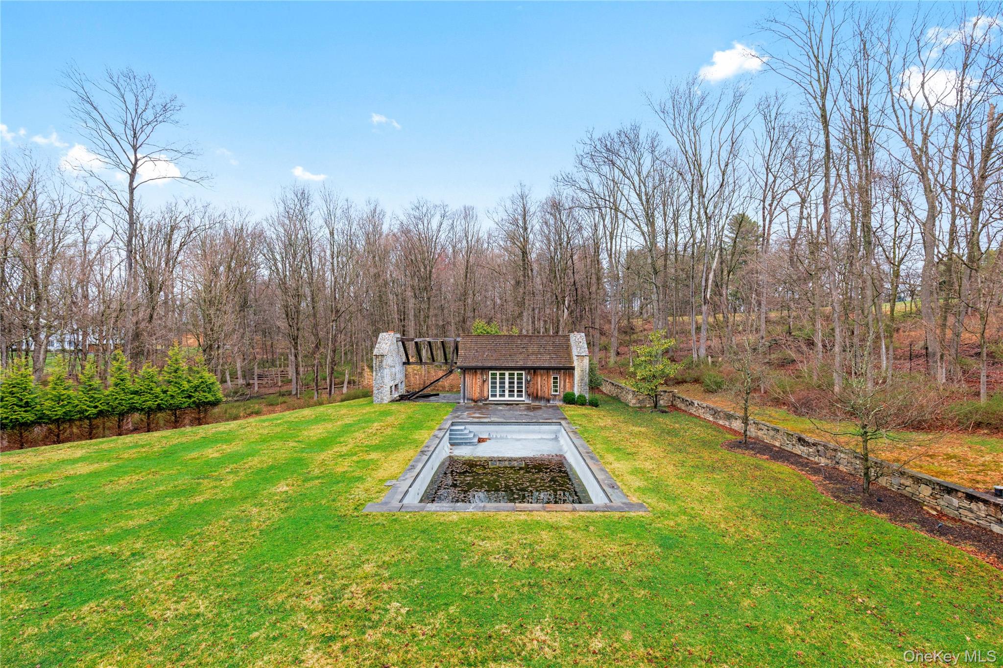 72 Guard Hill Road Bedford Corners, NY 10549 - Photo 40 of 50 a view of a backyard with swimming pool