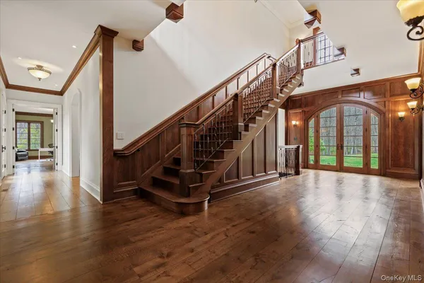 a view of entryway and hall with wooden floor
