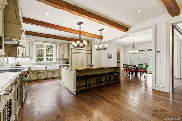 a large white kitchen with stainless steel appliances