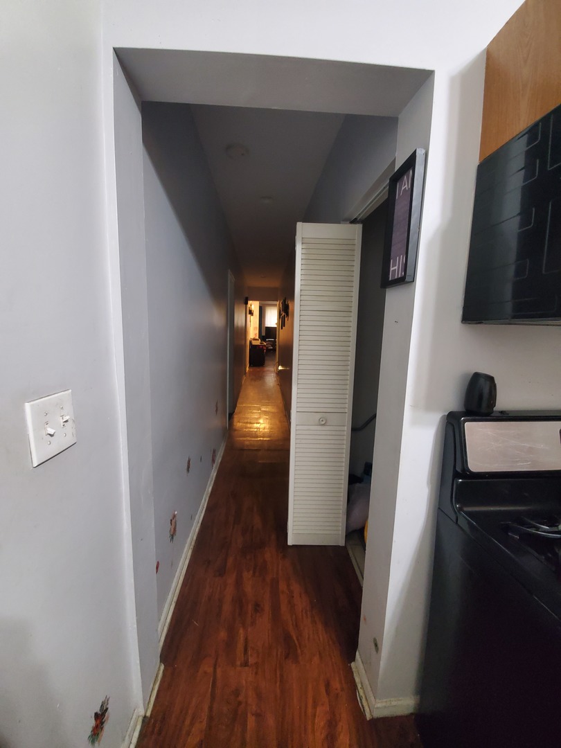 Undisclosed Address Chicago, IL 60623 - Photo 16 of 21 a view of hallway with wooden floor