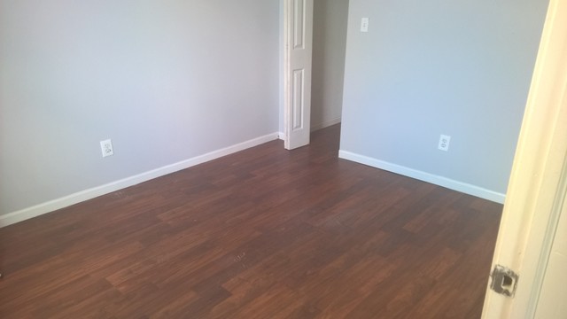 Undisclosed Address Chicago, IL 60623 - Photo 18 of 21 an empty room with wooden floor and windows