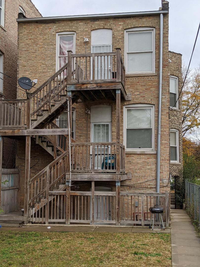 Undisclosed Address Chicago, IL 60623 - Photo 4 of 21 a view of a house with swimming pool