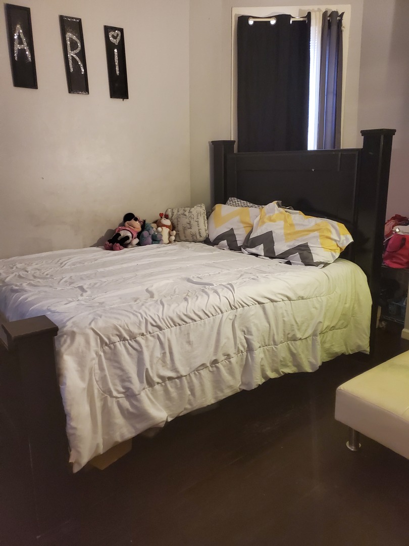 Undisclosed Address Chicago, IL 60623 - Photo 8 of 21 a bedroom with a bed and wall painting