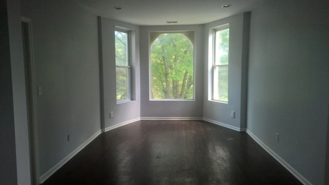 Undisclosed Address Chicago, IL 60623 - Photo 9 of 21 an empty room with wooden floor and windows