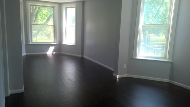 Undisclosed Address Chicago, IL 60623 - Photo 10 of 21 an empty room with wooden floor and windows