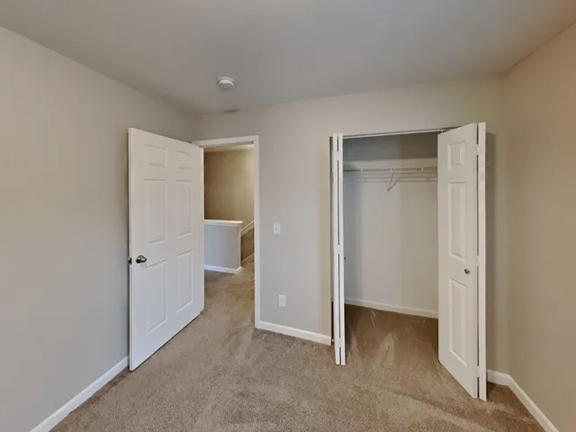 a view of a room with an empty space and a hallway