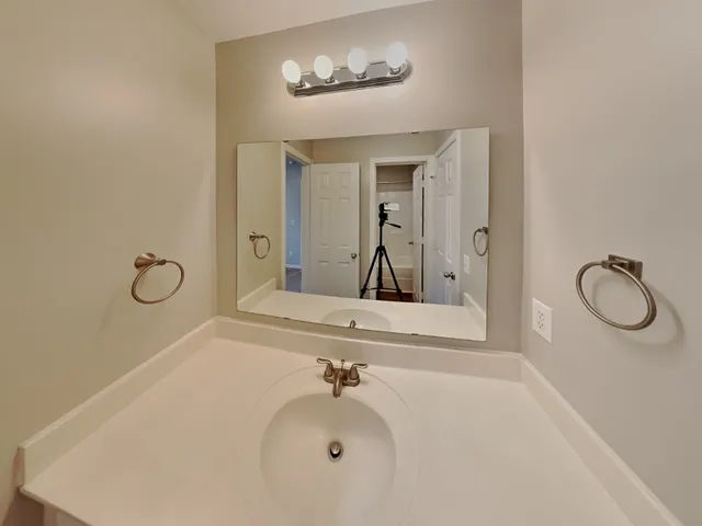 a bathroom with a sink and mirror