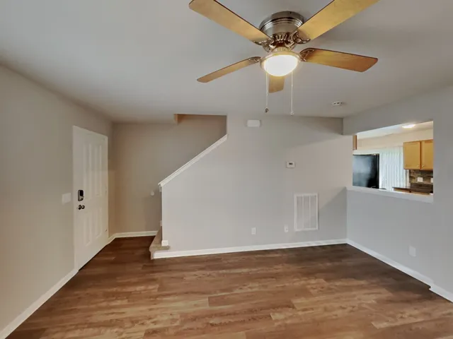 wooden floor in an empty room with a window
