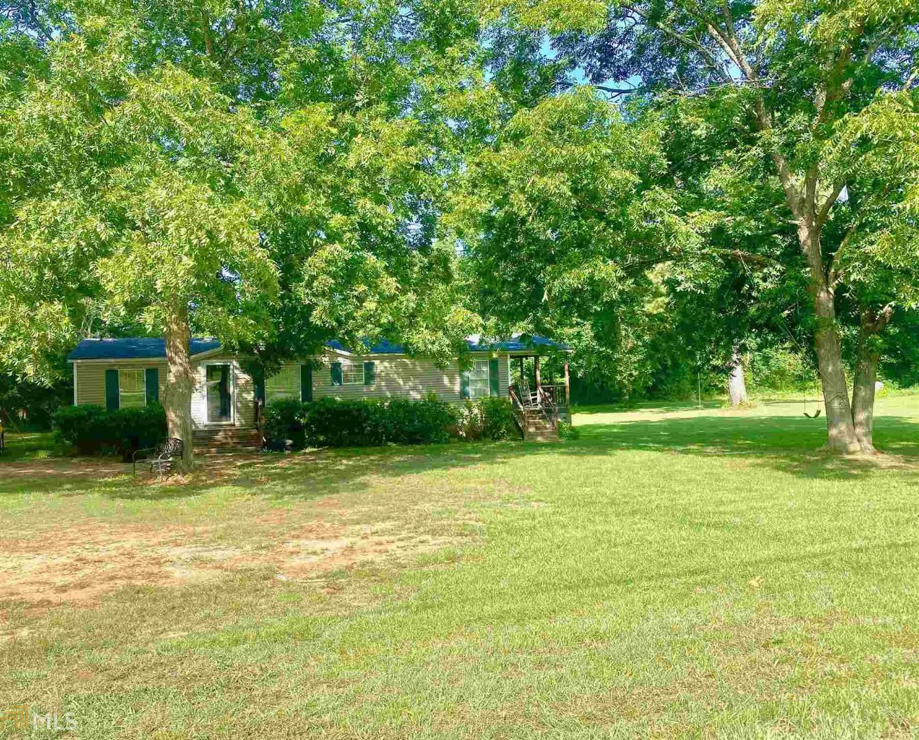 446 Adams Road Covington, GA 30014 - Photo 1 of 1 a view of a trees in front of a house