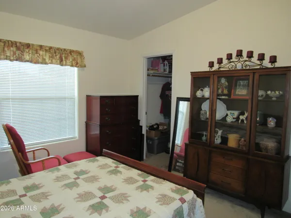 a bed sitting in a bedroom next to a window