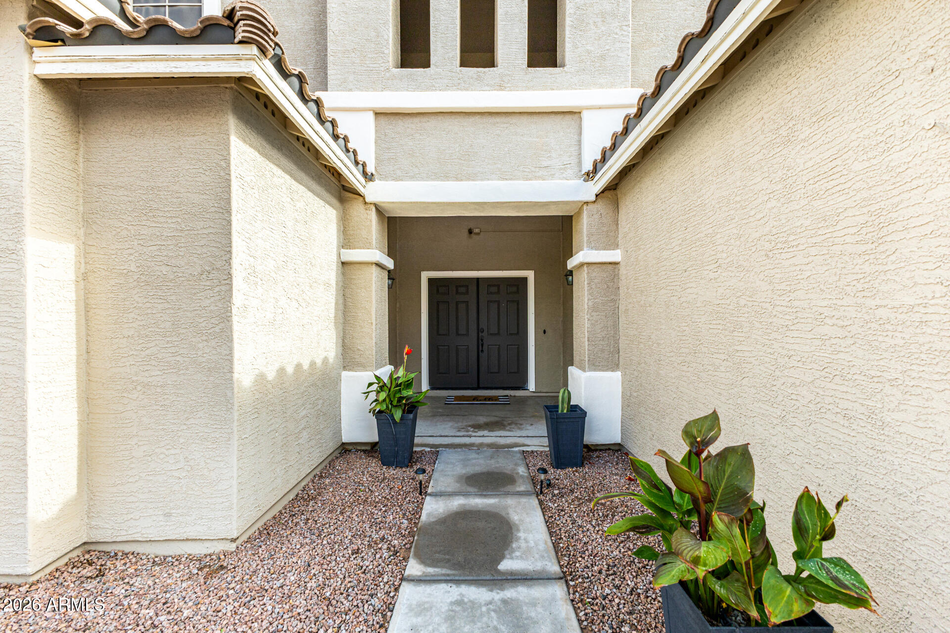 24541 Plum Road Florence, AZ 85132 - Photo 7 of 47 a front view of a house with potted plants