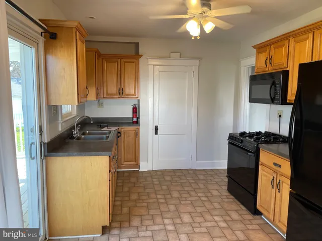 a kitchen with a refrigerator a stove top oven a sink and dishwasher