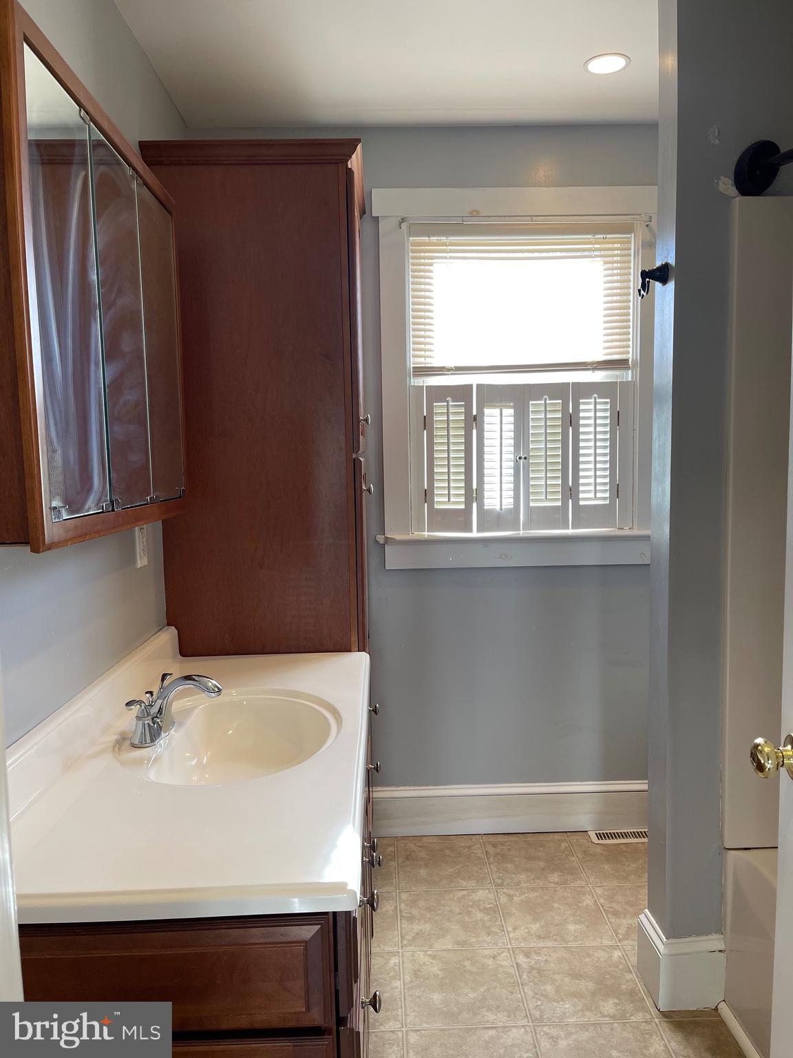 23 Addison Street Oxford, PA 19363 - Photo 8 of 15 a bathroom with a sink and a mirror