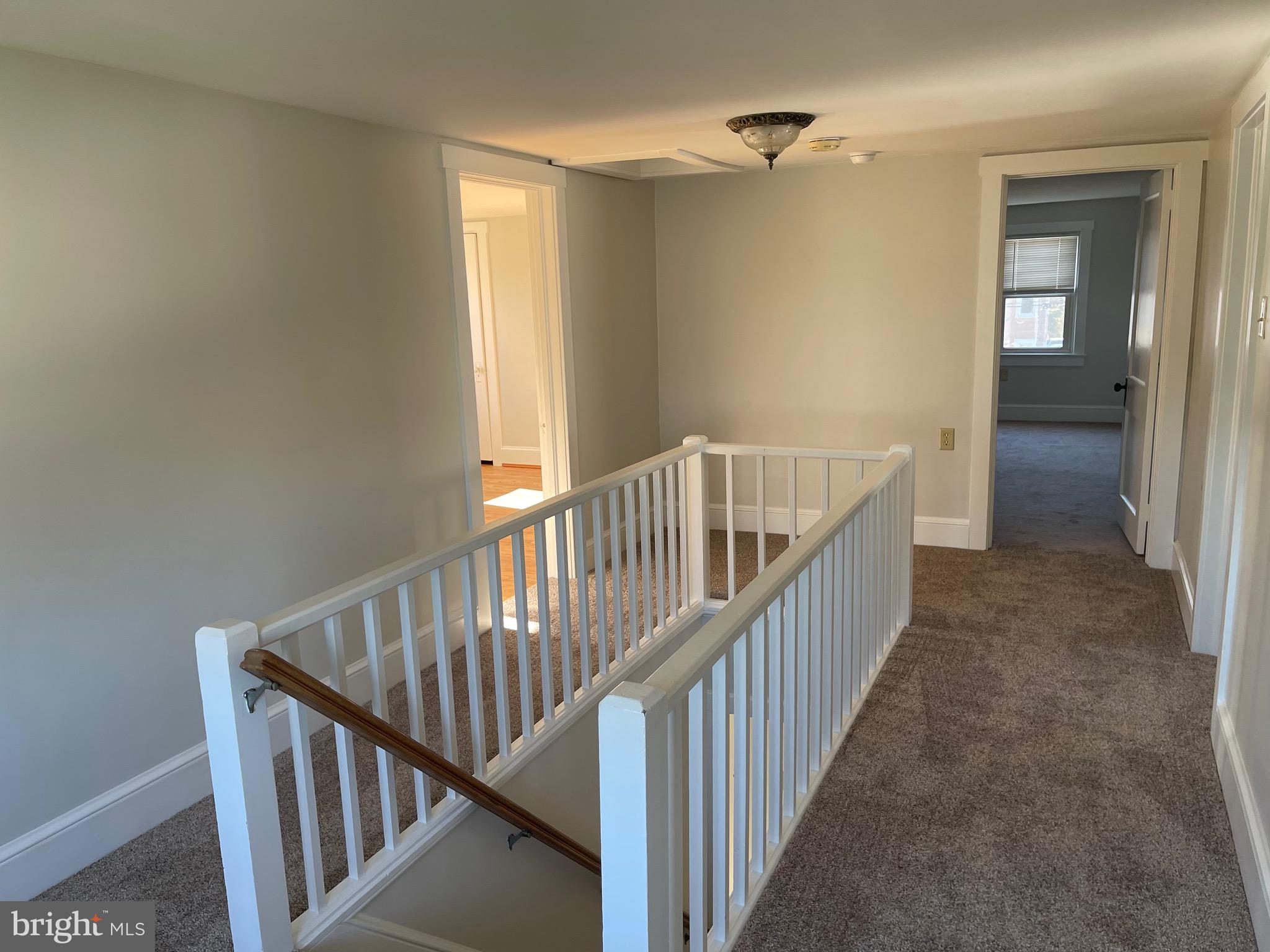 23 Addison Street Oxford, PA 19363 - Photo 9 of 15 a view of a hallway with wooden floor and staircase