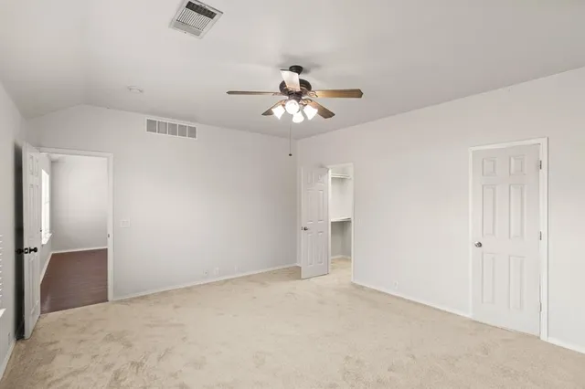 a view of a chandelier fan and entryway