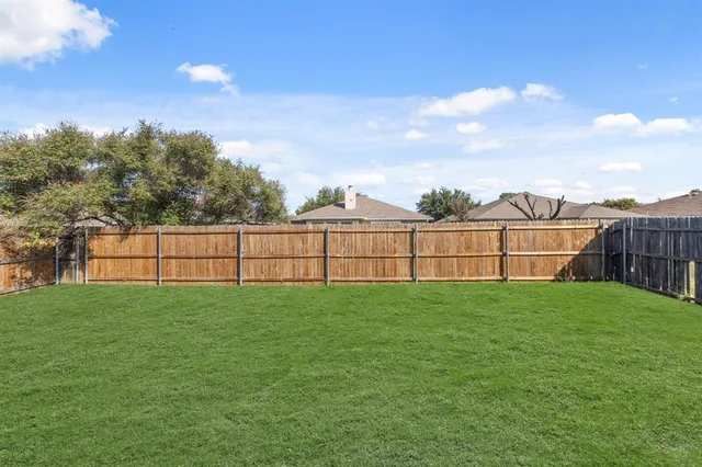 a view of a house with a yard and plants