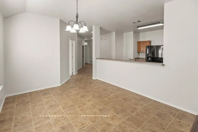 a view of a kitchen with a sink and a chandelier