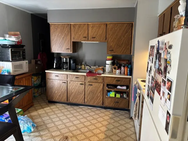 a kitchen with stainless steel appliances a sink and a refrigerator