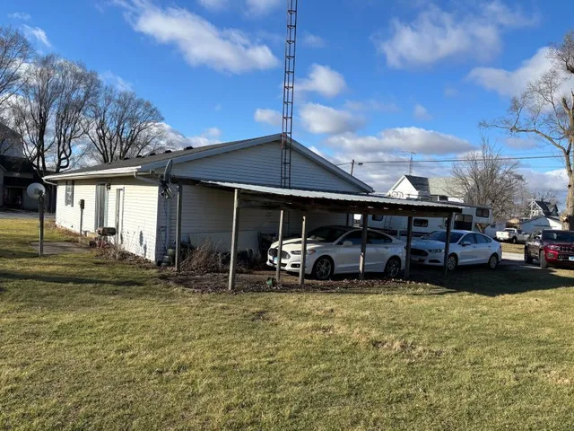 a view of a house with a yard and sitting area