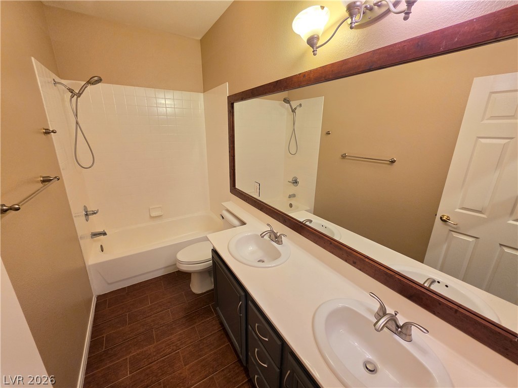 209 Opera House Street Henderson, NV 89012 - Photo 20 of 45 A spacious double vanity and a classic tub shower combo anchor this functional bathroom layout.