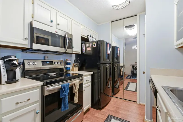 a kitchen with stainless steel appliances a stove microwave and a refrigerator