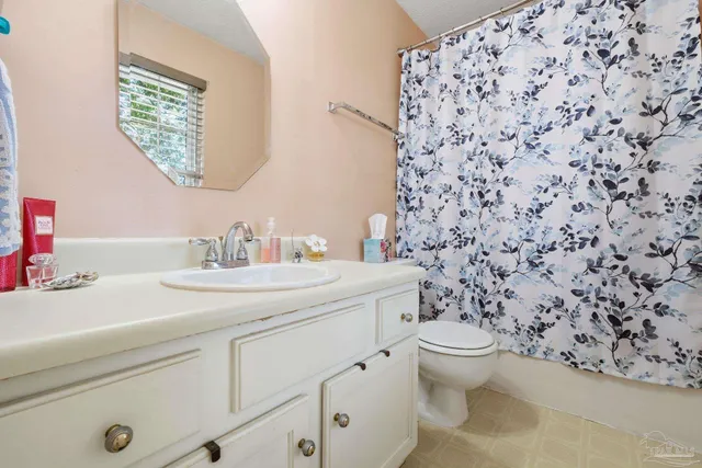 a bathroom with a sink toilet and a mirror