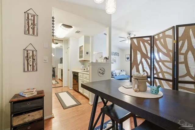 a living room with stainless steel appliances furniture a dining table and a stove top oven