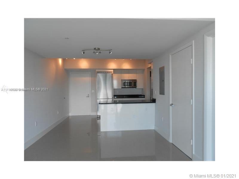 92 Southwest 3rd Street, Unit 3802 Miami, FL 33130 - Photo 2 of 10 a open kitchen with stainless steel appliances kitchen island sink refrigerator and stove