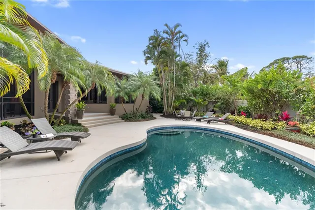 a swimming pool with outdoor seating and yard