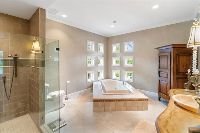 a living room with stainless steel appliances furniture a rug and a large window