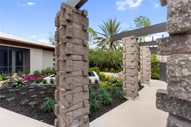 a front view of a house with a yard and potted plants