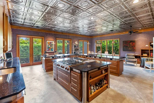 a kitchen with a stove and a large window