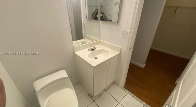 a bathroom with a sink toilet and mirror