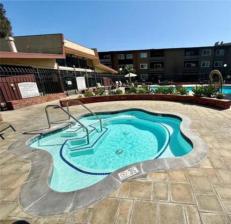 a view of a swimming pool with outdoor seating