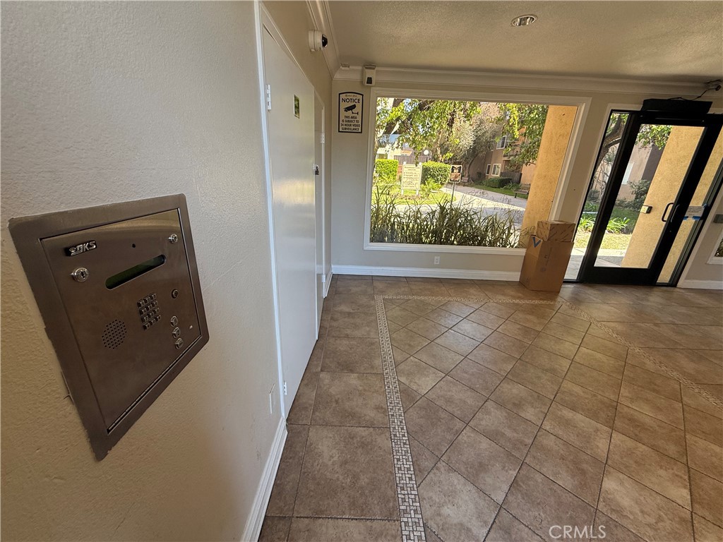 12200 Montecito Road, Unit D221 Seal Beach, CA 90740 - Photo 23 of 27 a view of a hallway with furniture and a gate