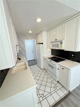 a kitchen with a sink a stove and refrigerator