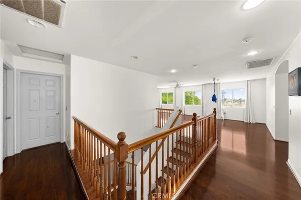 a view of a living room hardwood floor and a window