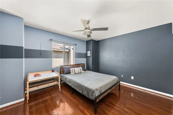 a bedroom with a bed and a ceiling fan