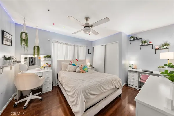 a bedroom with a bed furniture and a flat screen tv