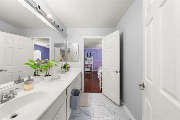 a white toilet sitting next to a bathroom sink and a window