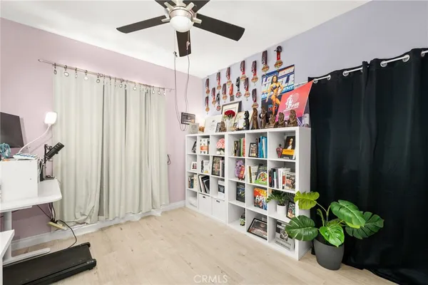 a room with lots of books and a large window