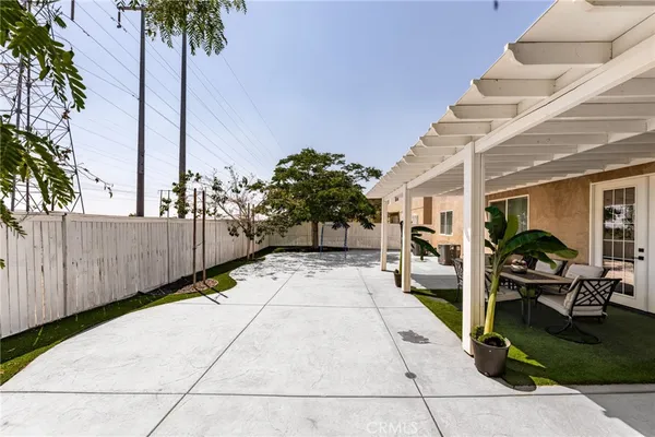 a view of a patio with couches chairs and a fire pit
